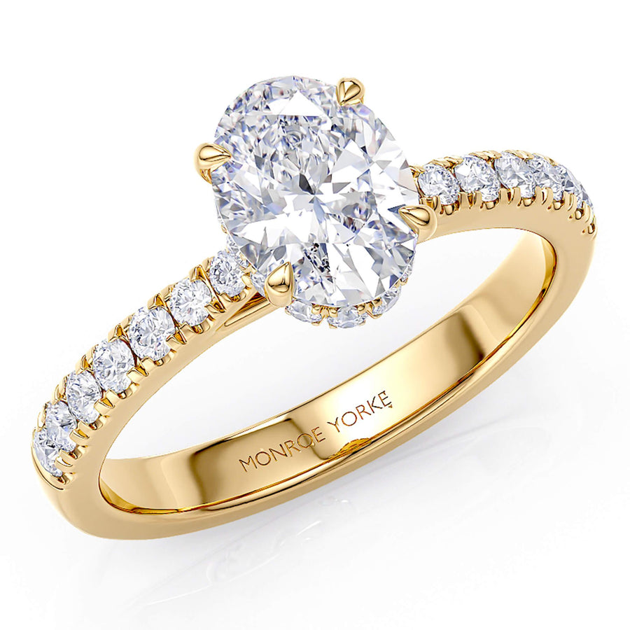 Paige - Oval diamond engagement ring.  Hidden halo on the side of the main diamond.  Diamonds on the sweep up and tapering band. 18ct gold ring