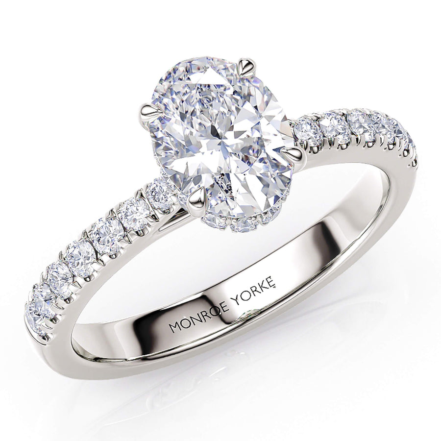 Paige - oval diamond engagement ring with a hidden diamond halo. Diamond set band tapers into the centre setting. 