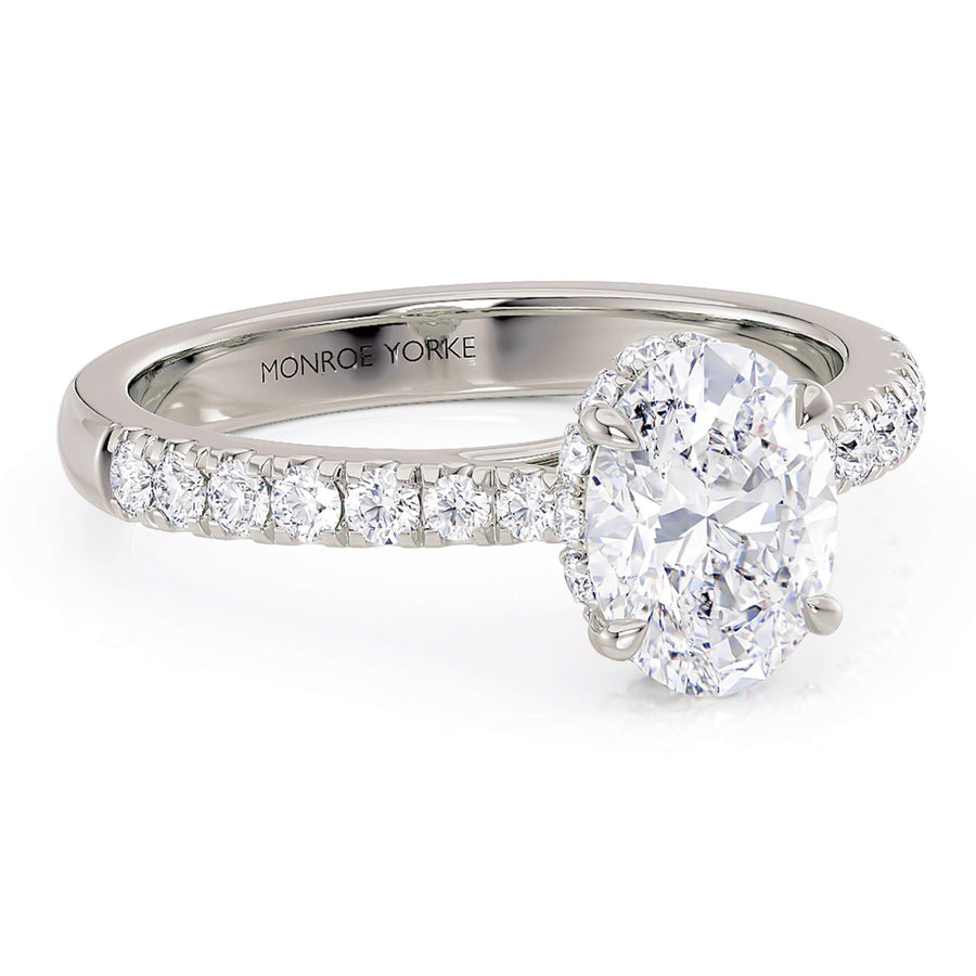 Side view of Paige oval diamond ring showing diamond set band that tapers into the centre setting
