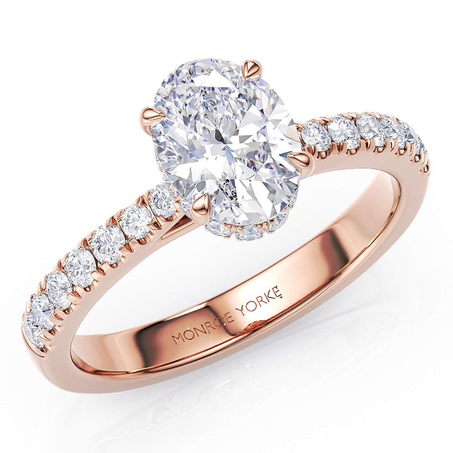 Paige oval diamond ring with a hidden halo.  Created in rich rose gold.  Band tapers into the centre setting