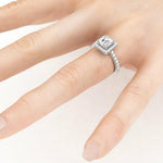Dawn princess cut diamond halo ring on a hand.