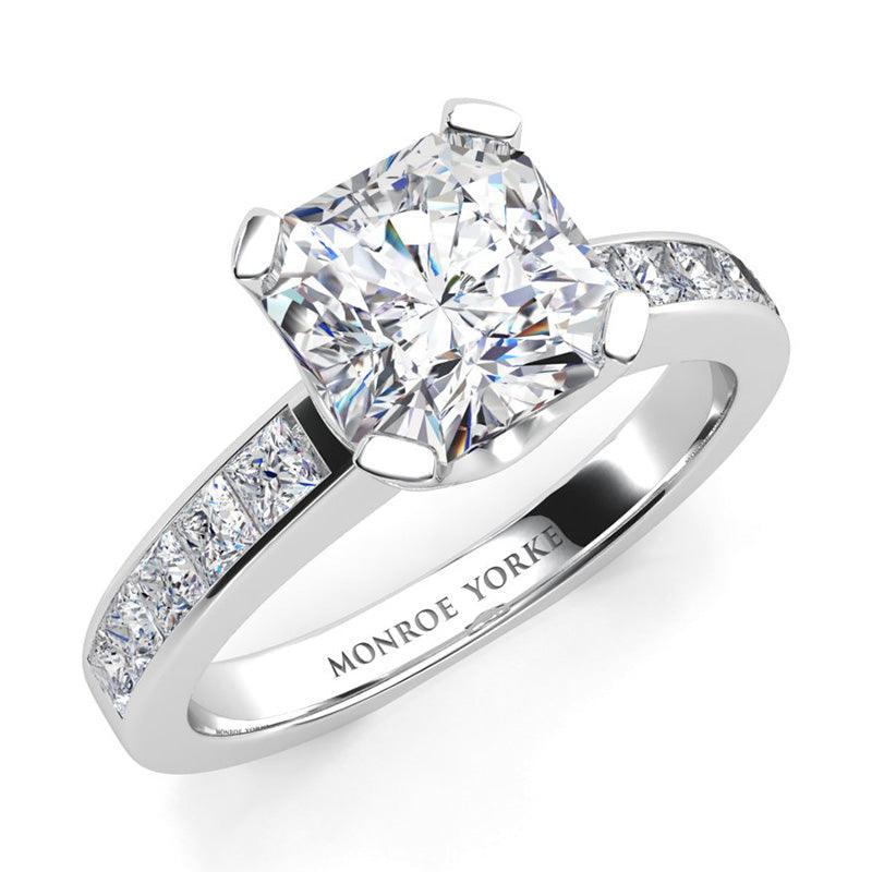 Radiance White Gold - radiant cut centre diamond, channel set princess cut diamonds on the band.  
