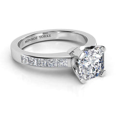 Radiance - radiant cut centre diamond, channel set princess cut diamonds on the band.  Side view