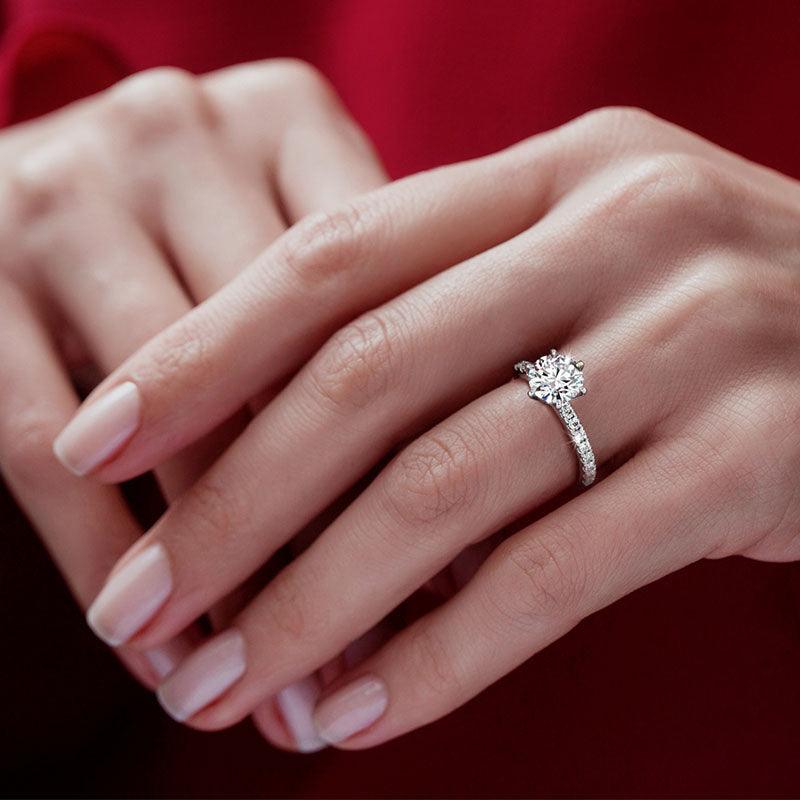 Scarlett round diamond engagement ring on a hand. Centre 6 claw setting — view 5