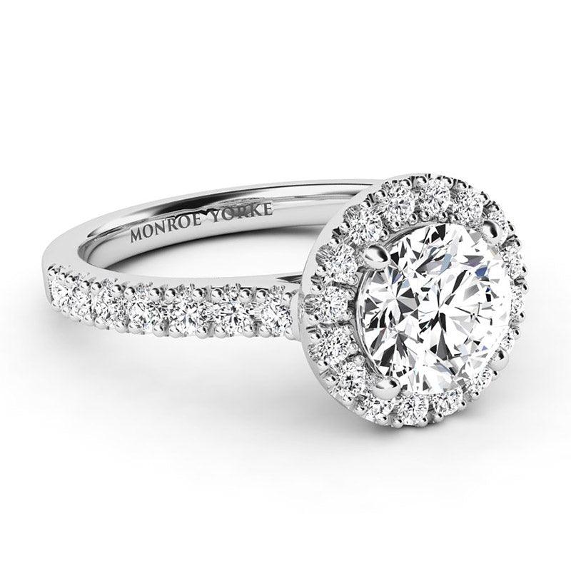 Serene Platinum - Side view showing round diamond halo and diamonds down the sweep up band. 