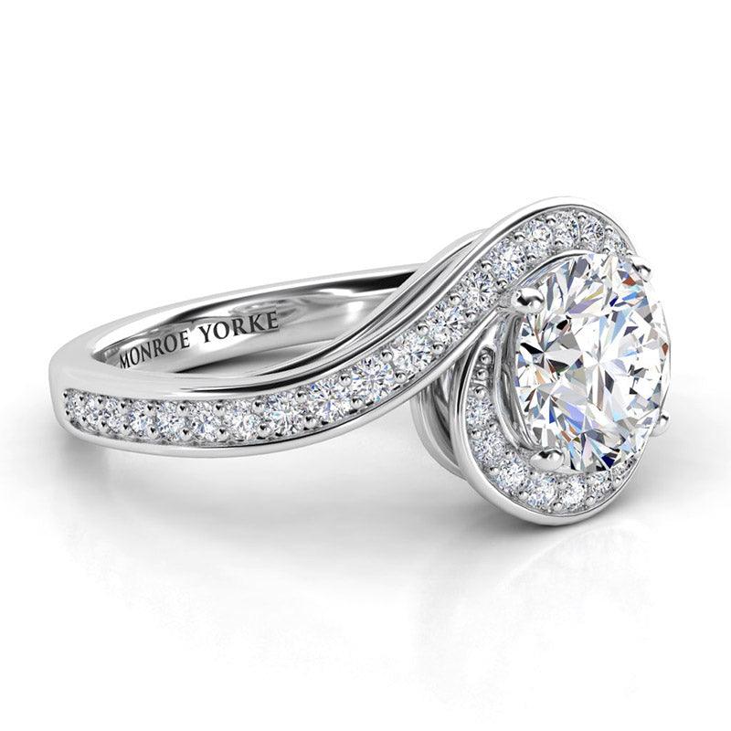 Side view showing the unique halo that wraps the centre round diamond. Tempest, created in platinum. 