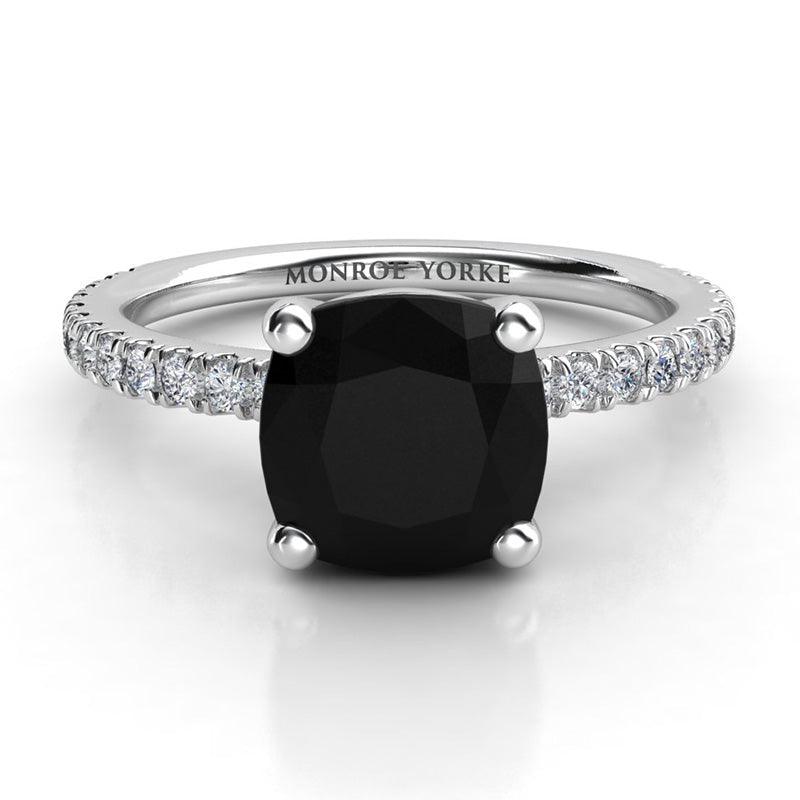 Storm - Platinum, top view. Centre cushion cut black diamond ring with white diamonds on the band.  