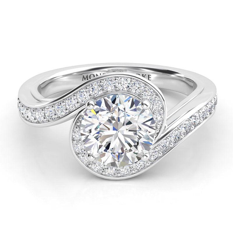 Unique halo wraps the centre round diamond engagement ring. Tempest, created in platinum. 