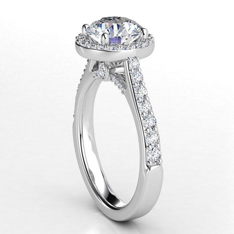 Victoria in platinum - round diamond halo engagement ring.  Diamond highlights on the under-rail. 