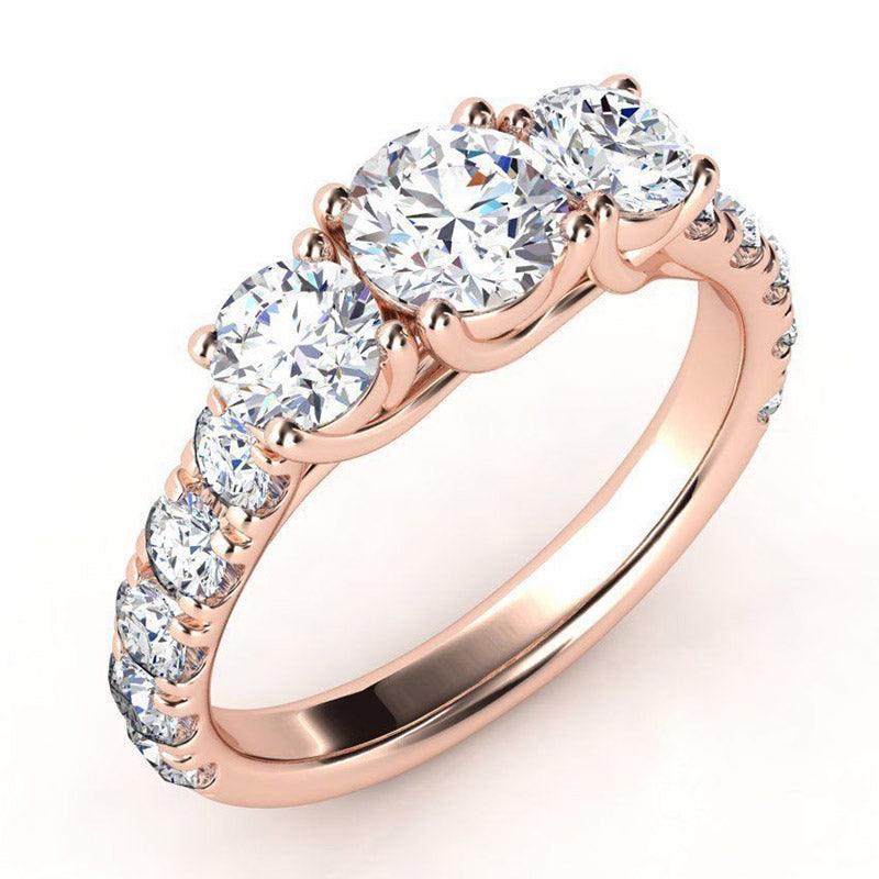 Zuri beautiful three diamond ring with large diamonds on the band. Rose Gold