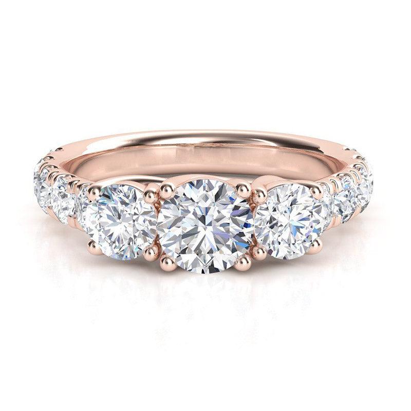 Beautiful trilogy diamond ring with large diamonds on the band. Rose Gold