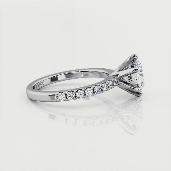 Scarlet - round diamond engagement ring with a centre 6 claw setting. Diamonds on the band.