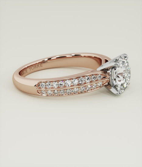 The beauty of a round brilliant cut diamond enhanced on this stunning engagement ring setting